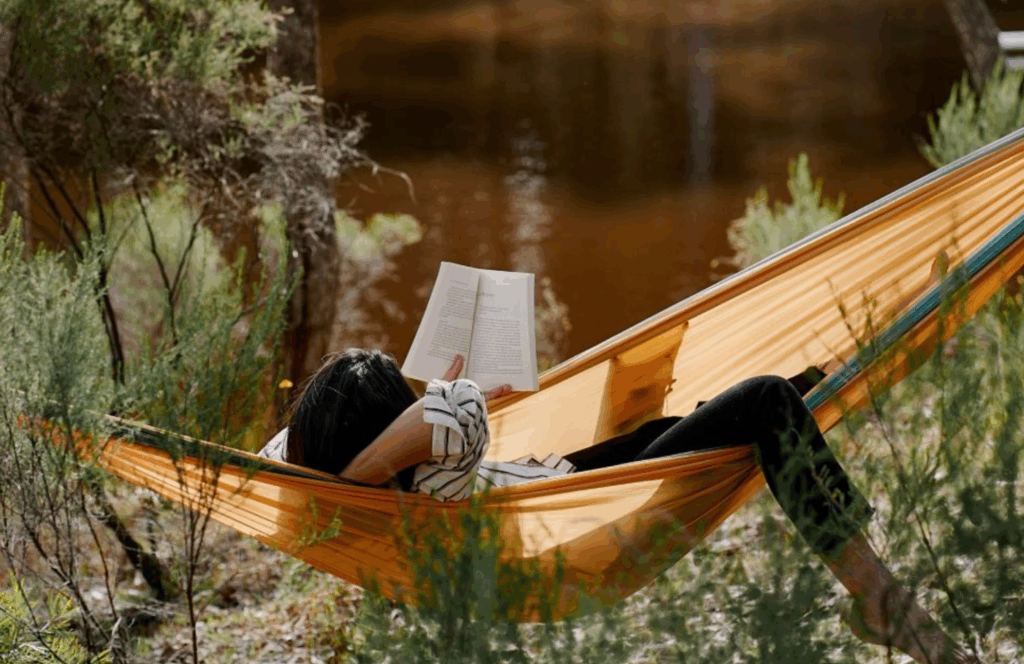 Read under tree surrounded by nature at Marcel tiny cabin in Victoria
